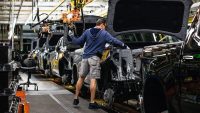 A worker installs an engine at the General Motors assembly plant in Fort Wayne, Indiana, US.