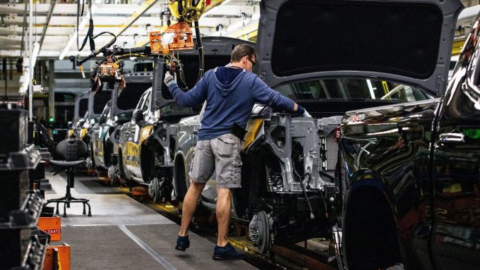 A worker installs an engine at the General Motors assembly plant in Fort Wayne, Indiana, US.