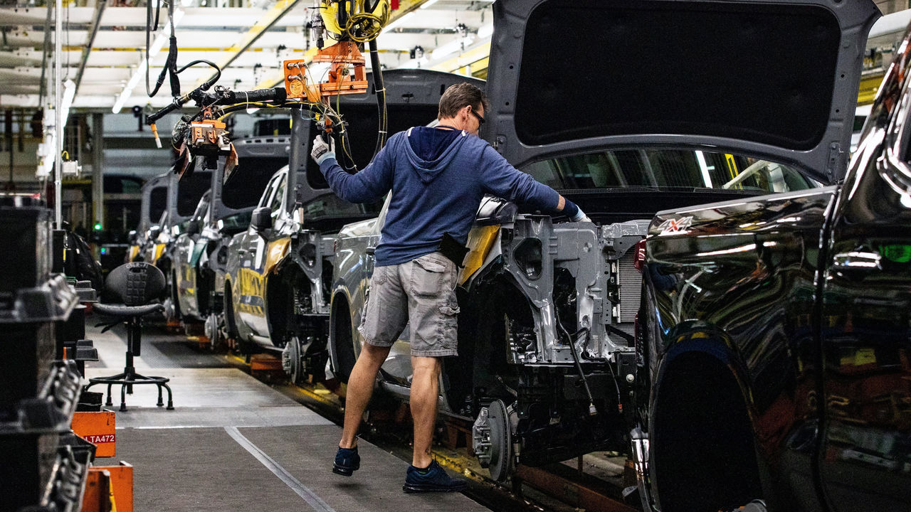 A worker installs an engine at the General Motors assembly plant in Fort Wayne, Indiana, US.