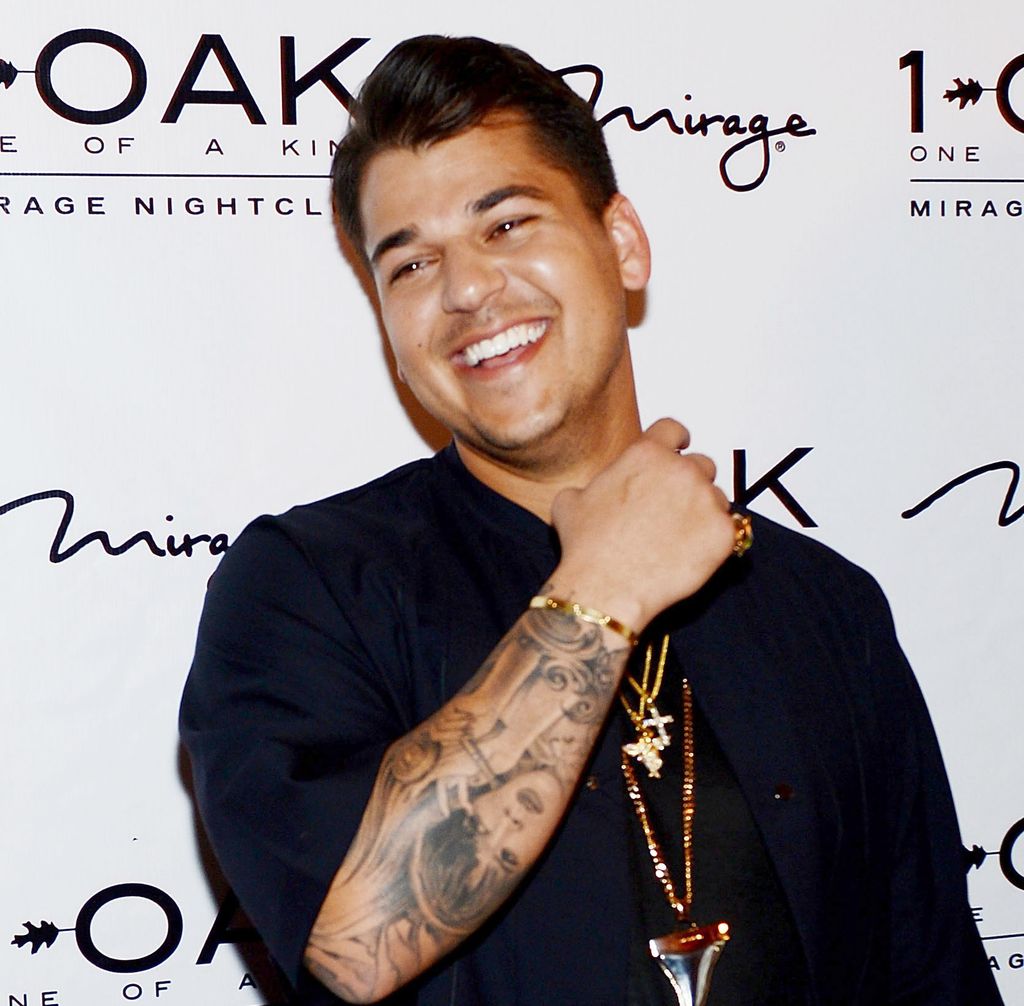 Rob Kardashian smiles as she shows off his tattoos during red carpet appearance