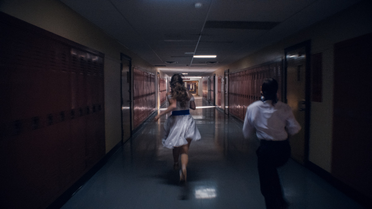 Students running down a school hallway