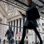 People walking along Wall Street in New York before President Trump's tarriff announcments