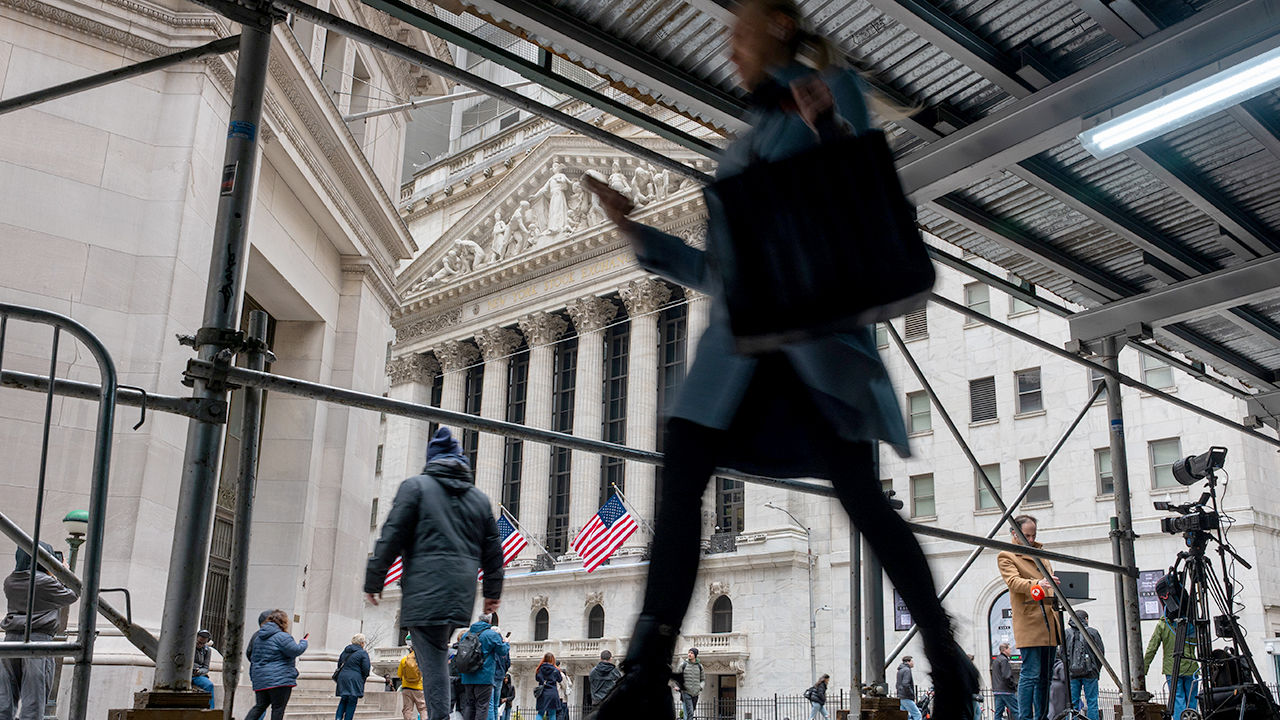 People walking along Wall Street in New York before President Trump's tarriff announcments