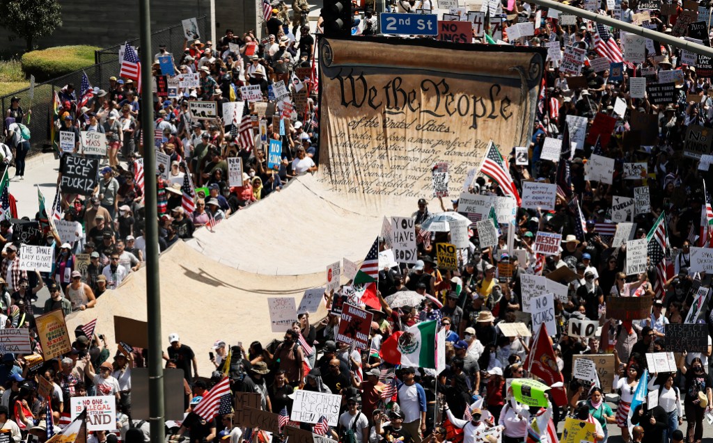 LOS ANGELES, CALIFORNIA - JUNE 14: Protesters carry a banner representing the Preamble to the U.S. Constitution in downtown Los Angeles during an anti-Trump "No Kings Day" demonstration on June 14, 2025 in Los Angeles, California. Hundreds of marches and protests against the Trump administration and its policies are happening across the United States today. Protesters are also reacting in opposition to a planned military parade celebrating the 250th anniversary of the U.S. Army that is taking place in Washington, DC and which coincides with President Trump's birthday. (Photo by Mario Tama/Getty Images)