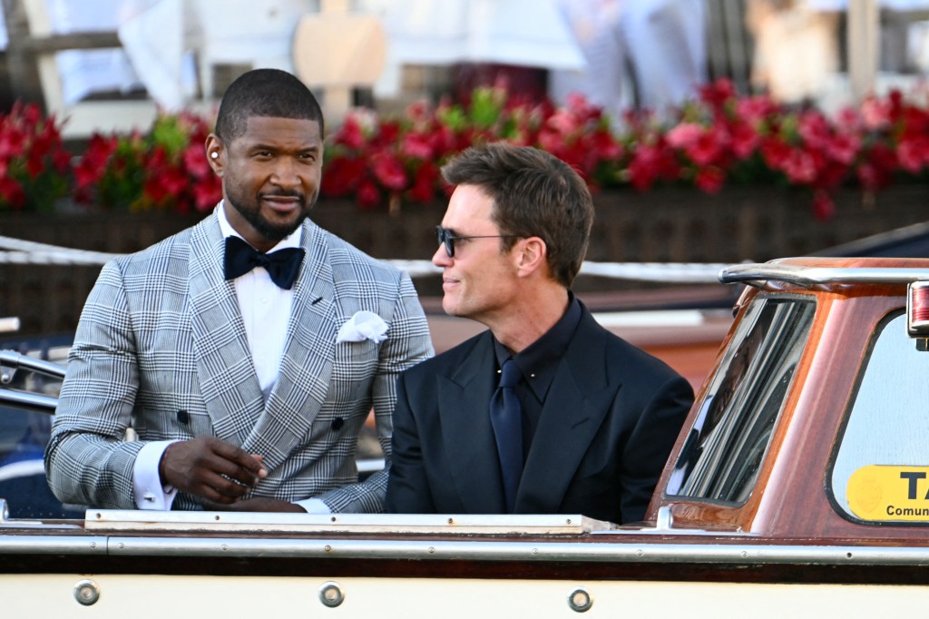 US singer Usher Raymond IVl (L) and US football player Tom Brady leave the Gritti Palace Hotel on the wedding day of Amazon founder Jeff Bezos with Lauren Sanchez, in Venice on June 27, 2025. (Photo by Stefano Rellandini / AFP) (Photo by STEFANO RELLANDINI/AFP via Getty Images)